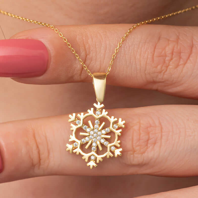 Collana - Ciondolo a forma di fiocco di neve in tono oro con zirconi cubici scintillanti